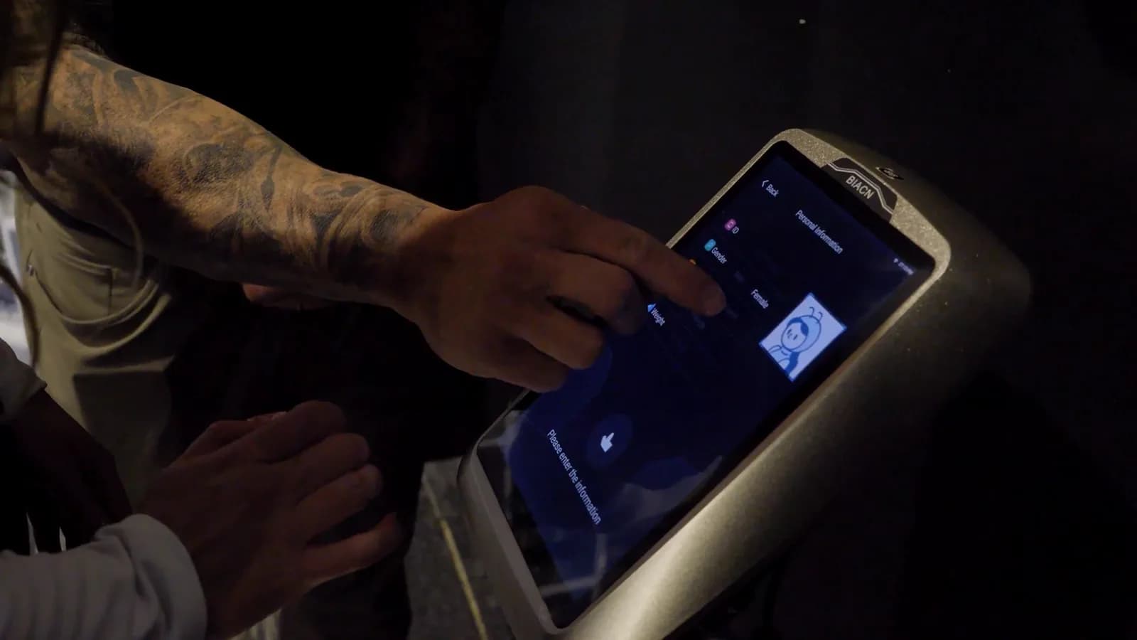 Member entering their details on the touchscreen of a body composition scanner at Inception Gym Christchurch