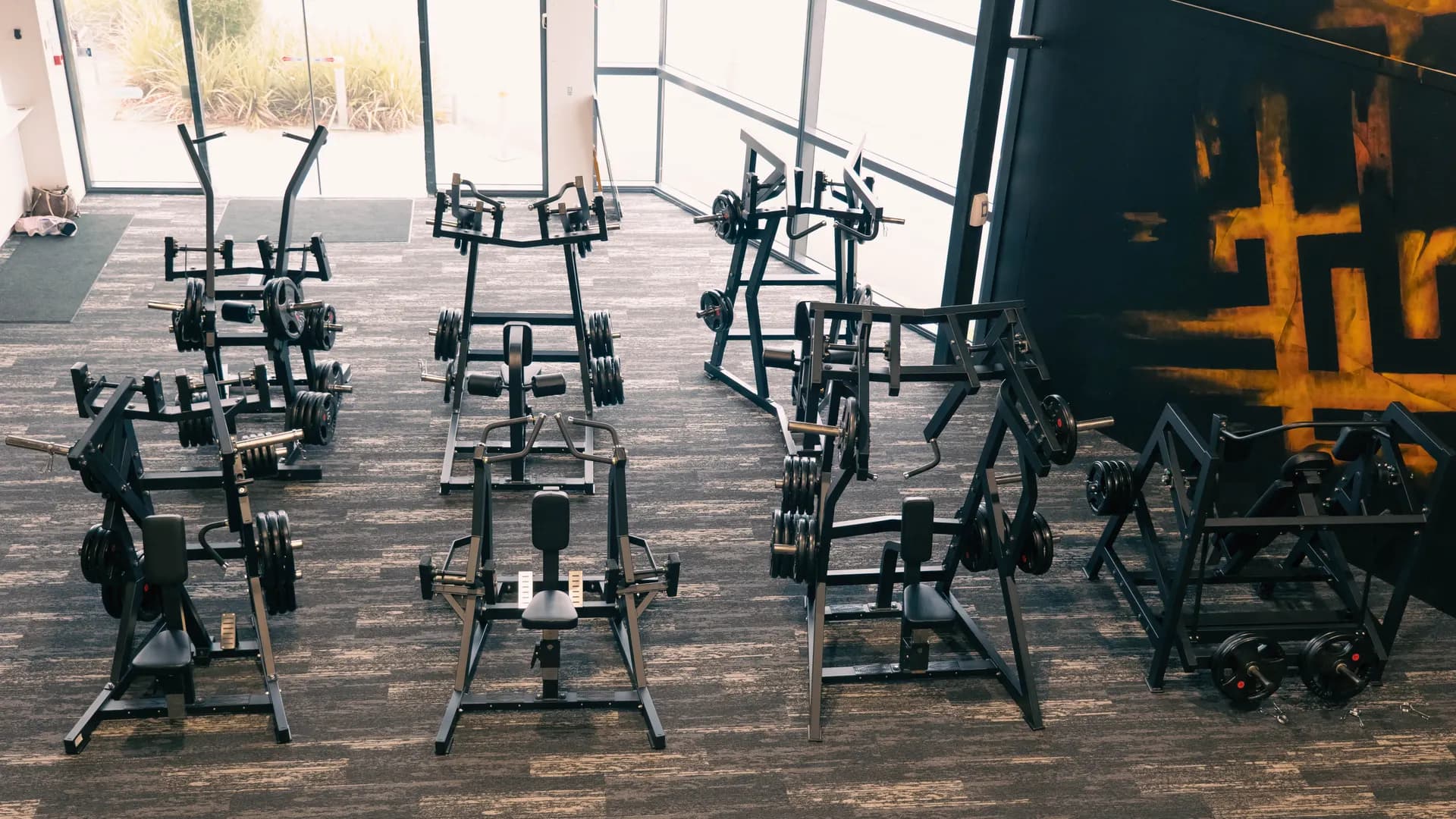 Pin-loaded back machines on the Inception Gym training floor